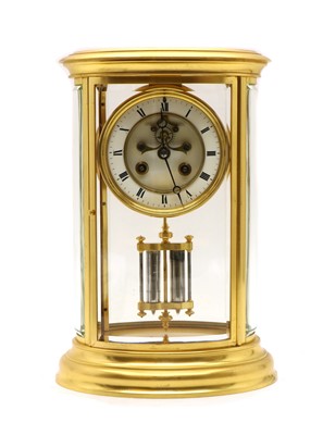 Lot 211 - A French four glass brass mantel clock