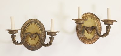 Lot 235 - A pair of gilt-bronze two-branch wall lights