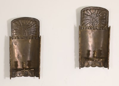 Lot 110 - A pair of pressed brass wall sconces