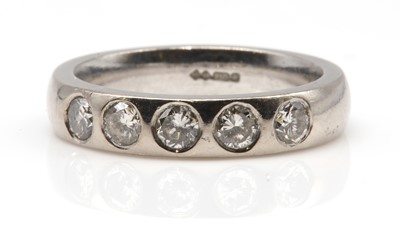 Lot 509 - An 18ct white gold diamond set half hoop band ring