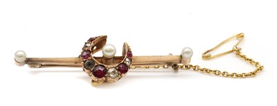 Lot 28 - A gold ruby, diamond, paste and pearl crescent bar brooch