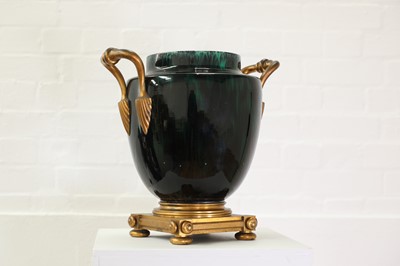 Lot 90 - A green flambé-glazed faience urn
