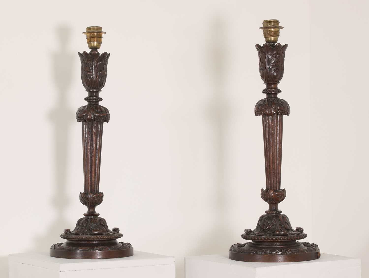 Lot 86 - A pair of Edwardian carved mahogany table lamps