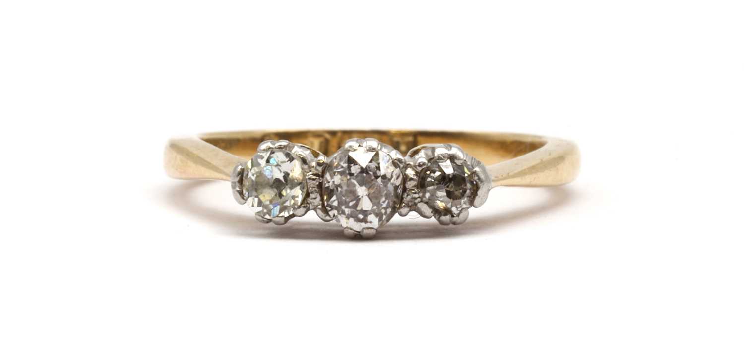 Lot 74 - A gold three stone old cut diamond ring