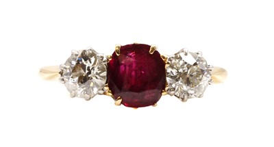 Lot 99 - A gold ruby and diamond three stone ring