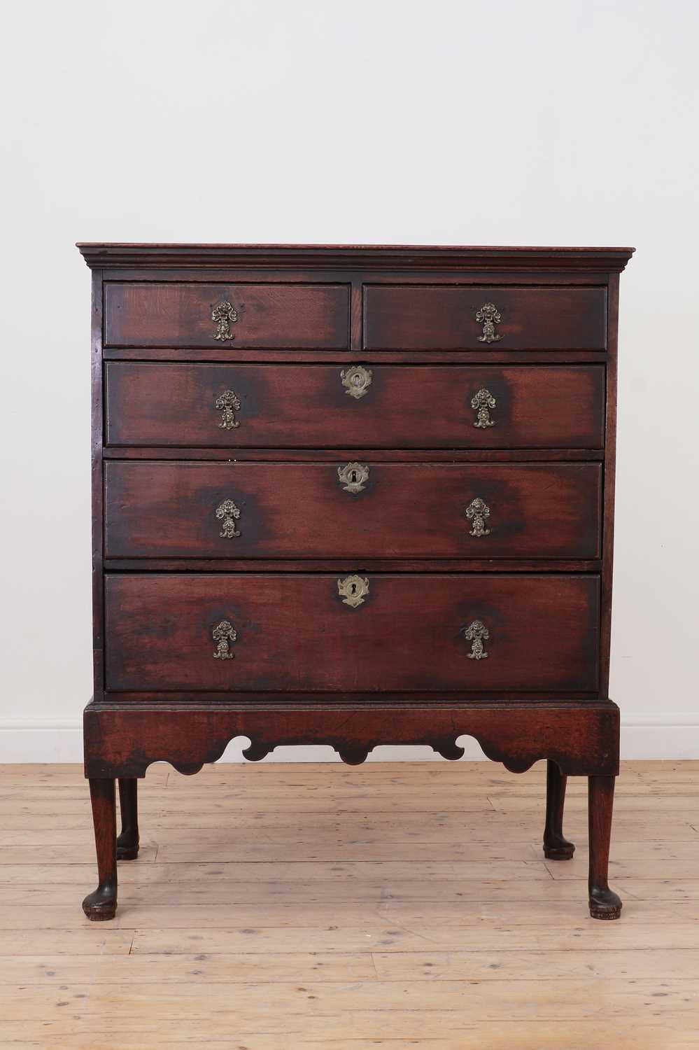 Lot 579 - A George II oak chest on stand