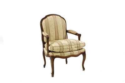 Lot 303 - A Louis XV style stained beech armchair