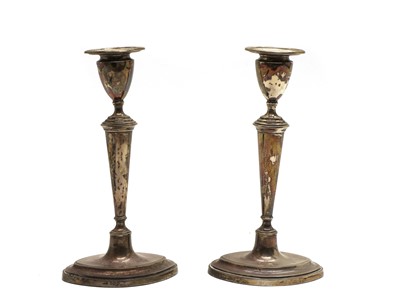 Lot 16 - A pair of Edwardian silver candlesticks