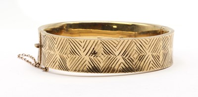 Lot 240 - A 9ct gold oval hinged bangle