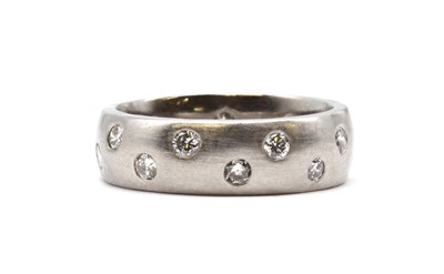 Lot 508 - A platinum diamond set shallow court section band ring