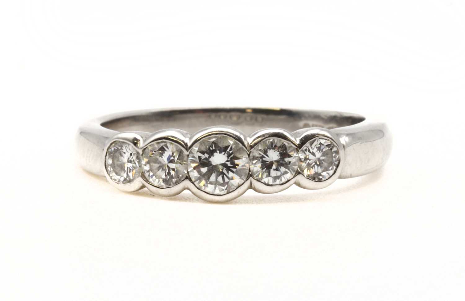 Lot 90 - A platinum five stone diamond ring
