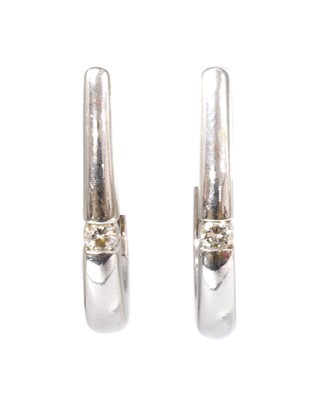 Lot 97 - A pair of white gold diamond hoop earrings