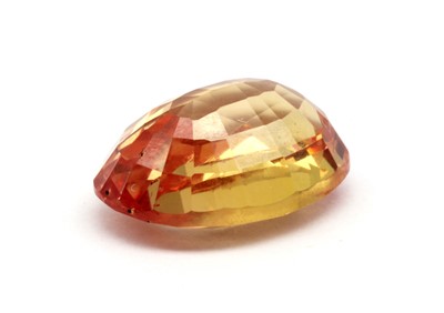 Lot 158 - An unmounted oval mixed cut orange-yellow sapphire