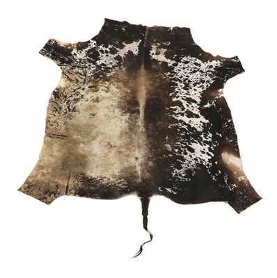 Lot 230A - A cowhide floor rug