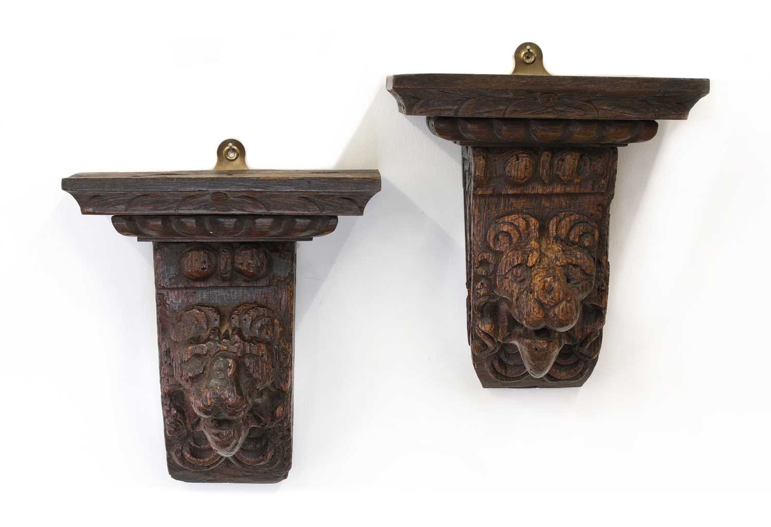 Lot 53 - A pair of early lion mask carved oak corbels