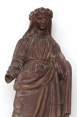 Lot 559 - A Continental carved limewood figure of Saint Rose of Lima