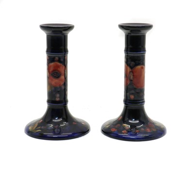 Lot 207 - A pair of William Moorcroft pottery ‘Pomegranate’ pattern candlesticks