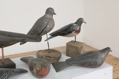 Lot 416 - A flock of carved wooden and painted decoy pigeons