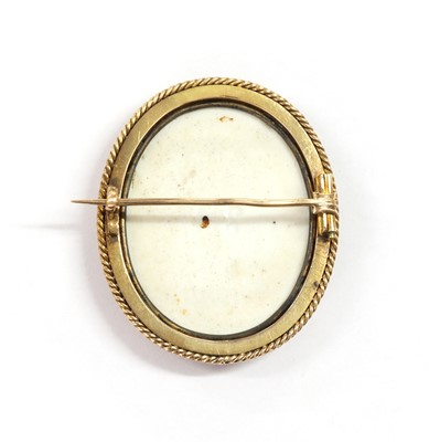 Lot 25 - A gold mounted porcelain plaque brooch