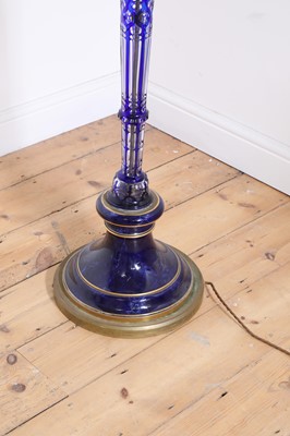 Lot 199 - An overlaid glass and brass standard lamp