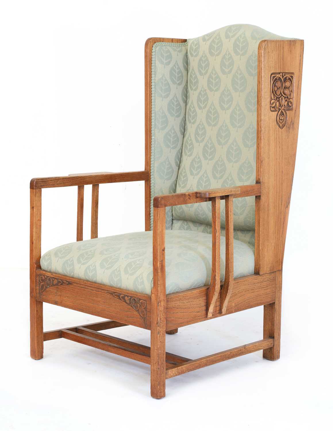Lot 67 - An Arts and Crafts oak wing-back armchair