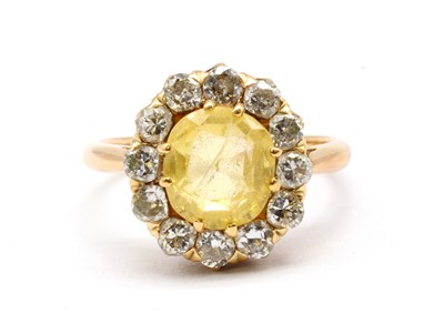 Lot 148 - A gold yellow sapphire and diamond cluster ring