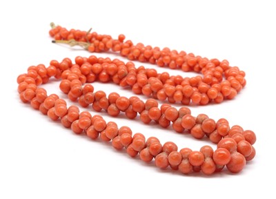 Lot 49 - A graduated carved coral bead necklace