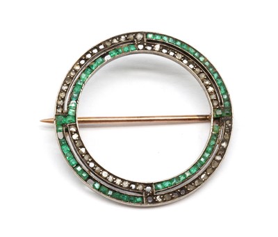 Lot 36 - A gold emerald and diamond circle brooch