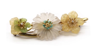 Lot 77 - A gold carved gemstone flower and diamond brooch