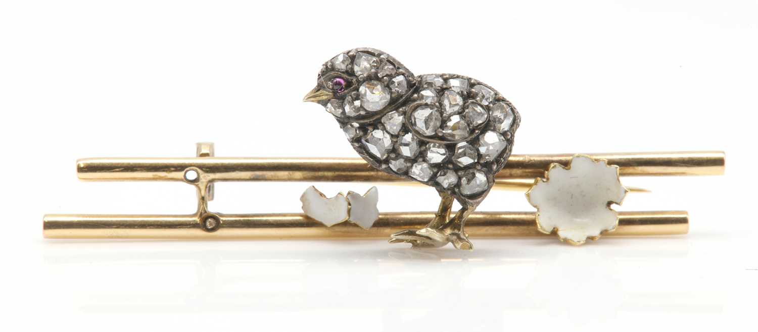 Lot 65 - An Edwardian ruby, diamond and enamel hatching chick and shell brooch