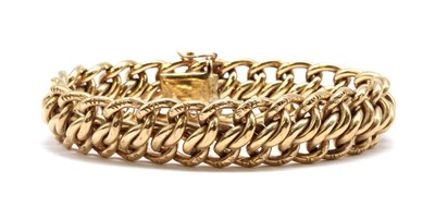 Lot 242 - A 9ct gold hollow engraved double curb link bracelet