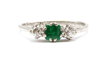Lot 152 - An emerald and diamond three stone ring