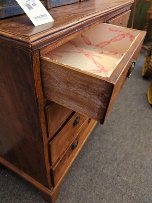 Lot 385 - A George III elm chest of drawers