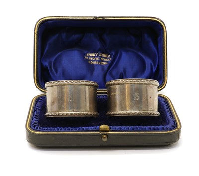 Lot 43 - A cased pair of late Victorian silver napkin rings