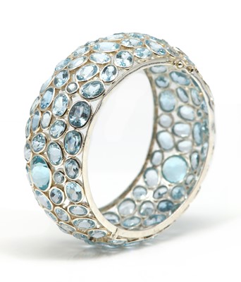 Lot 239 - A sterling silver blue topaz hinged bangle