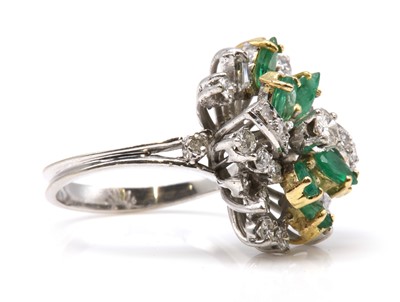 Lot 464 - A diamond and emerald spray style cocktail ring