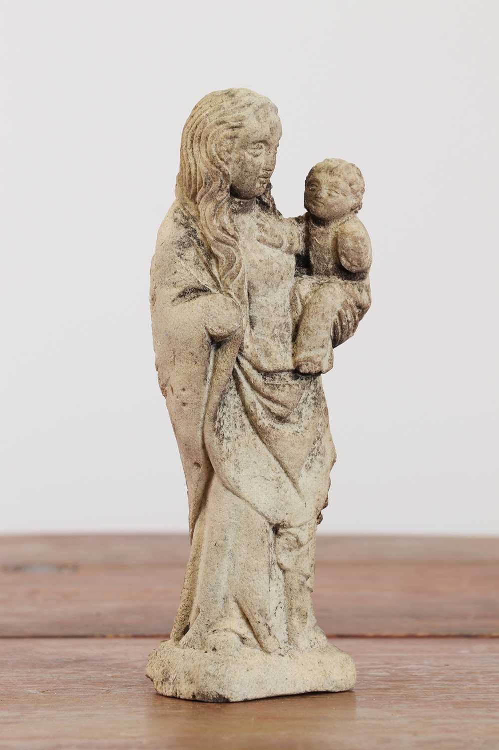 Lot 246 - A limestone carving of the Madonna and Child