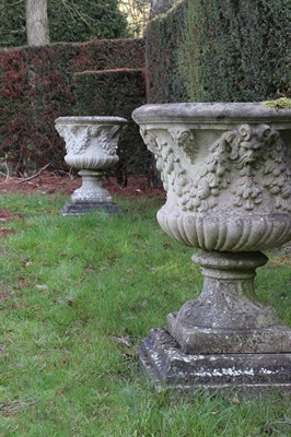 Lot 399 - A pair of weathered composite stone campana urns