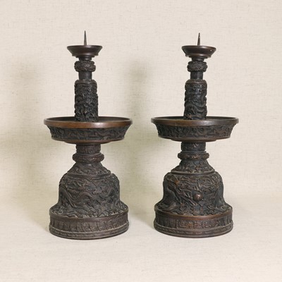 Lot 77 - A pair of Chinese cast bronze candlesticks
