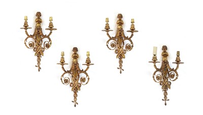 Lot 390 - A set of four neoclassical gilt-metal two-branch wall lights