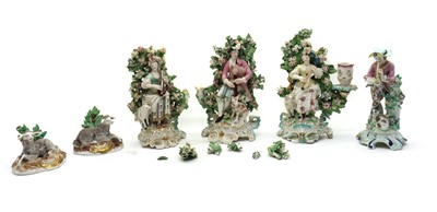 Lot 98 - A set of three Staffordshire porcelain bocage candlestick figures