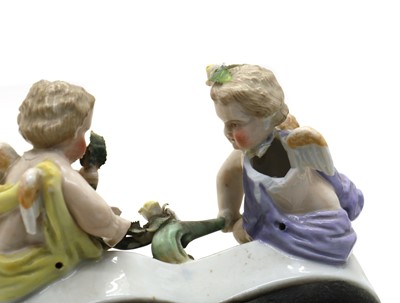 Lot 42 - A Dresden porcelain figure group of a hurdy-gurdy player and lady