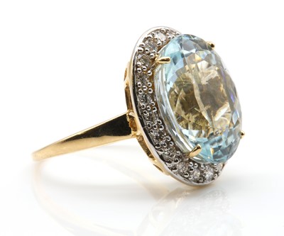 Lot 305 - An 18ct gold aquamarine and diamond oval cluster ring