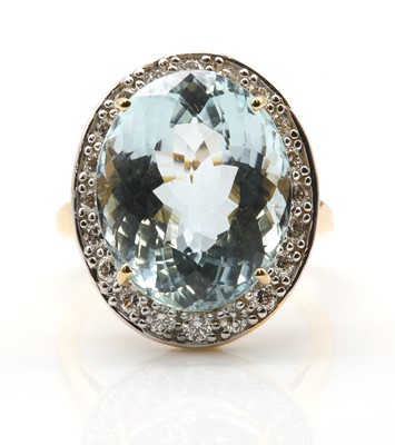 Lot 305 - An 18ct gold aquamarine and diamond oval cluster ring