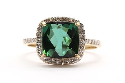 Lot 175 - An 18ct gold green tourmaline and diamond halo cluster ring