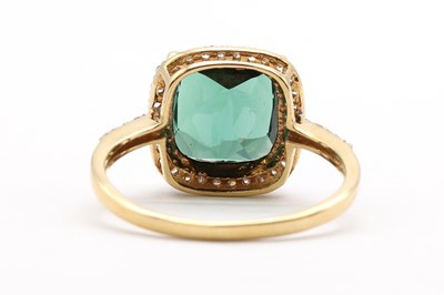 Lot 175 - An 18ct gold green tourmaline and diamond halo cluster ring