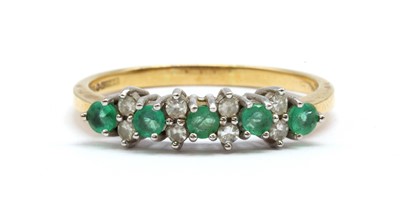 Lot 151 - An 18ct gold emerald and diamond ring