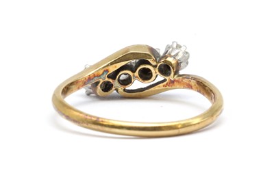 Lot 91 - A gold four stone diamond crossover ring