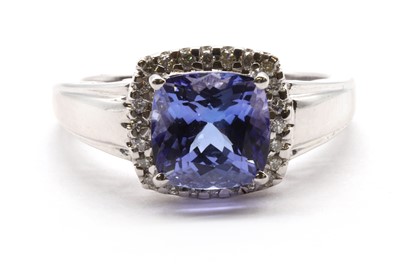 Lot 293 - An 18ct white gold tanzanite and diamond halo cluster ring