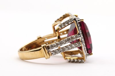 Lot 141 - An 18ct gold rubellite tourmaline and diamond halo cluster ring